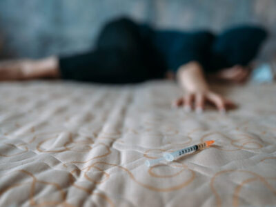 1686711102 female druggy with syringe in hand lies in bed 2021 08 26 16 26 46 utc 1 scaled 1 5